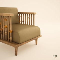 A solid wood statement chair with the arm and backrest made of multiple turned spindles, upholstered in rich colorful silk