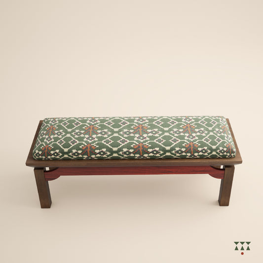 An artisanal solid wood bench with an upholstered seat in a printed Kilim fabric and legs in a tinted accent color