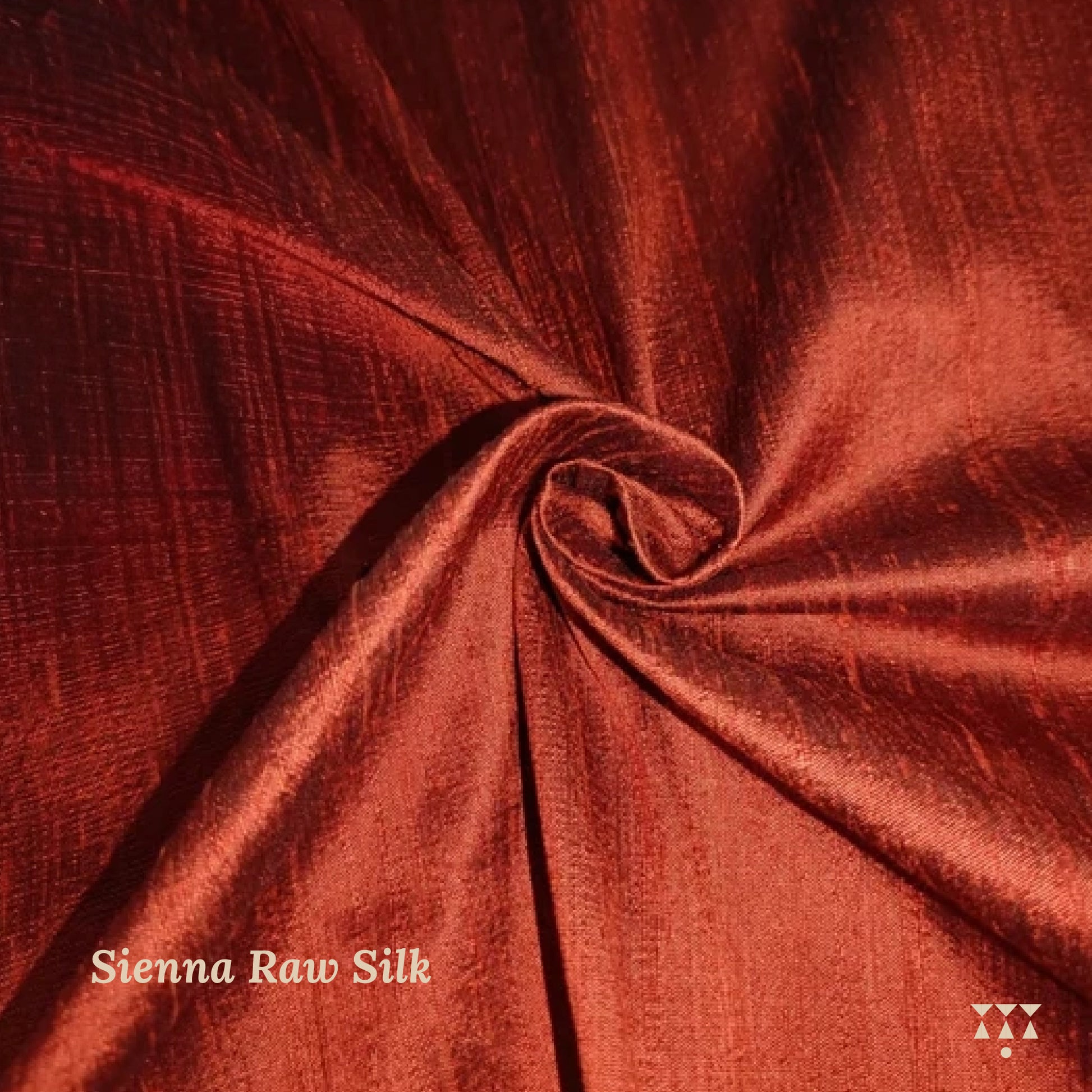 Close-up of Sienna Raw Silk fabric with a visible brand logo.