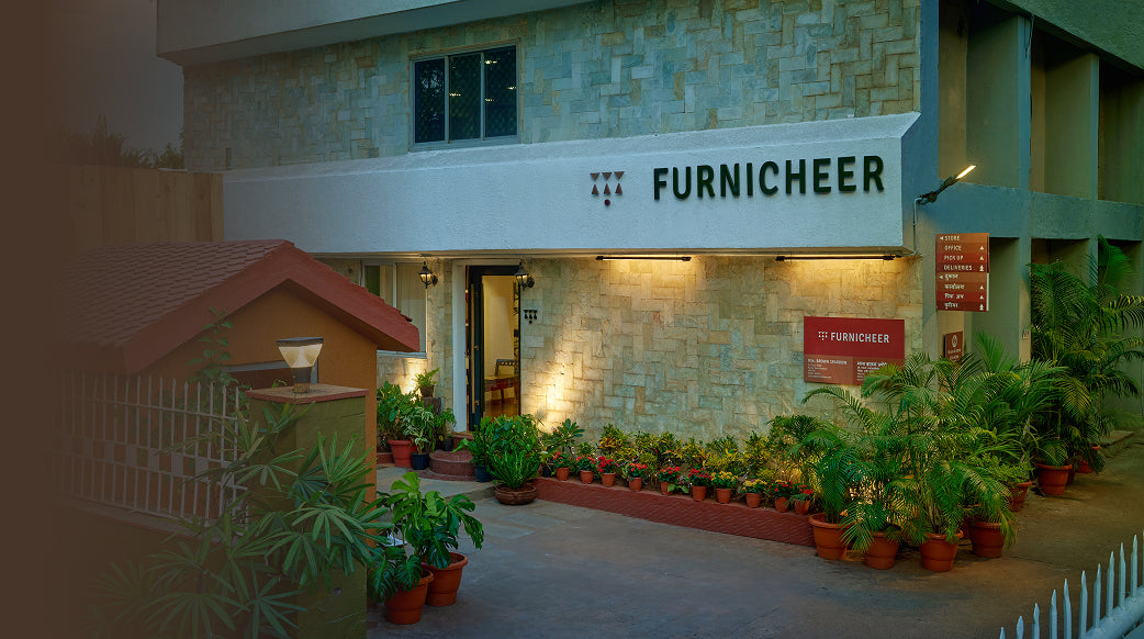 Furnicheer store front with plants and a signboard