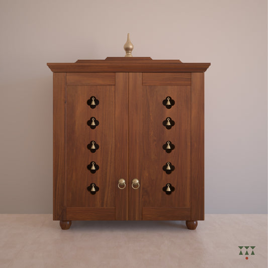 A solid wood mandir with doors, pure brass elements, cutwork designs and storage, tinted in almond brown