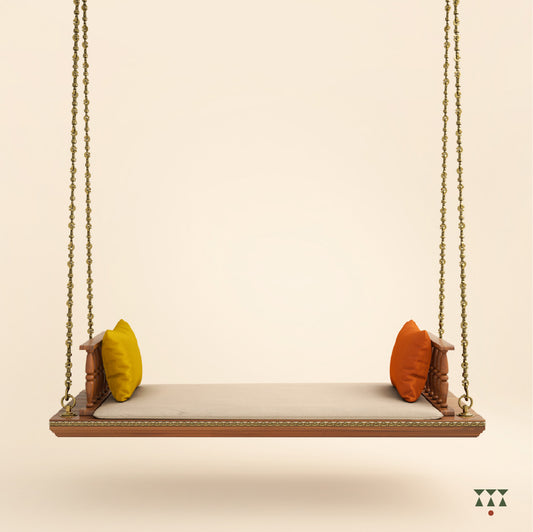 A solid wood swing with turned armrests, tinted in almond brown with decorative brass chains, a fabric seat and cushions