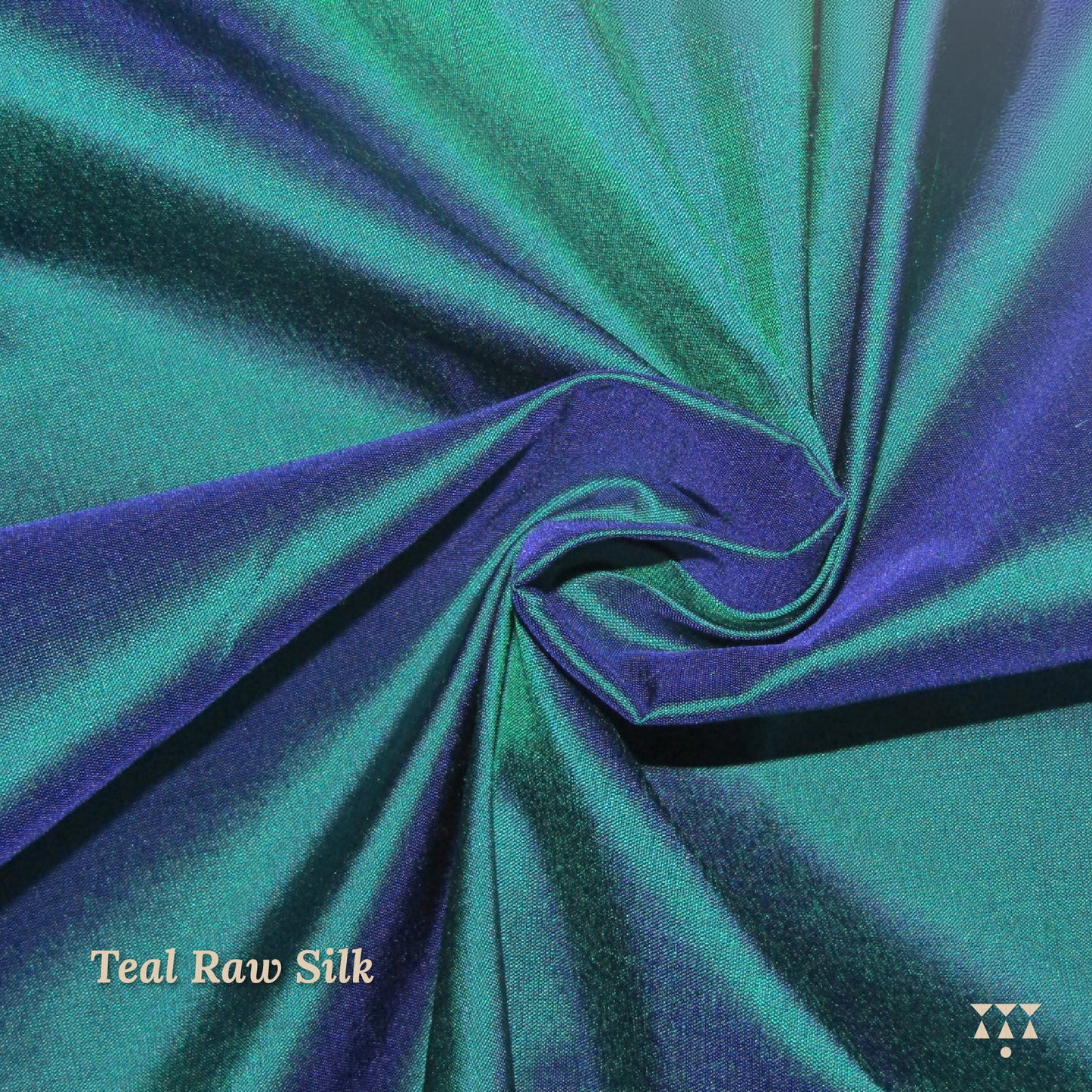 Close up of the teal raw silk upholstery fabric for the wing chair. 