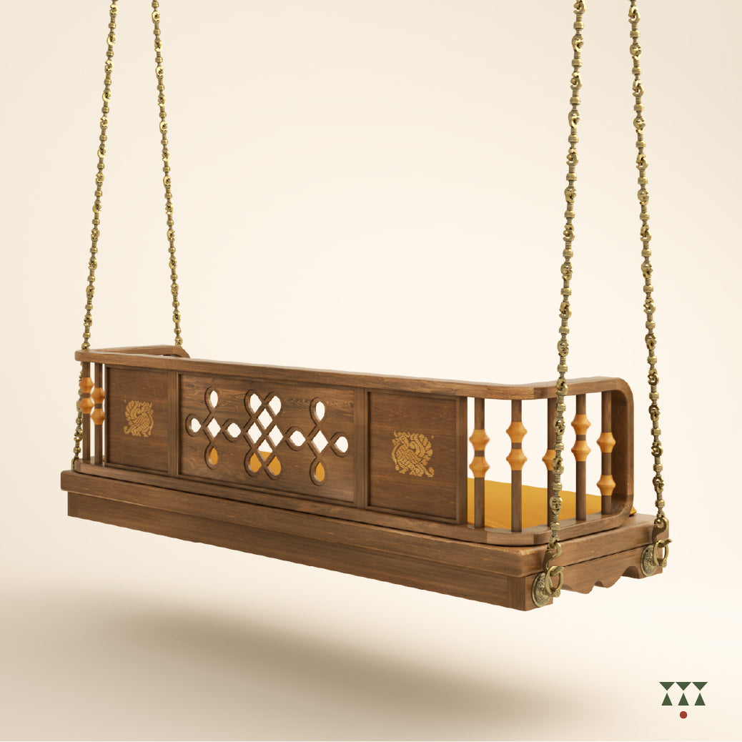 Close up of a wooden swing with Kolam, Annapakshi and floral designs and turning details on the backrest with a fabric seat