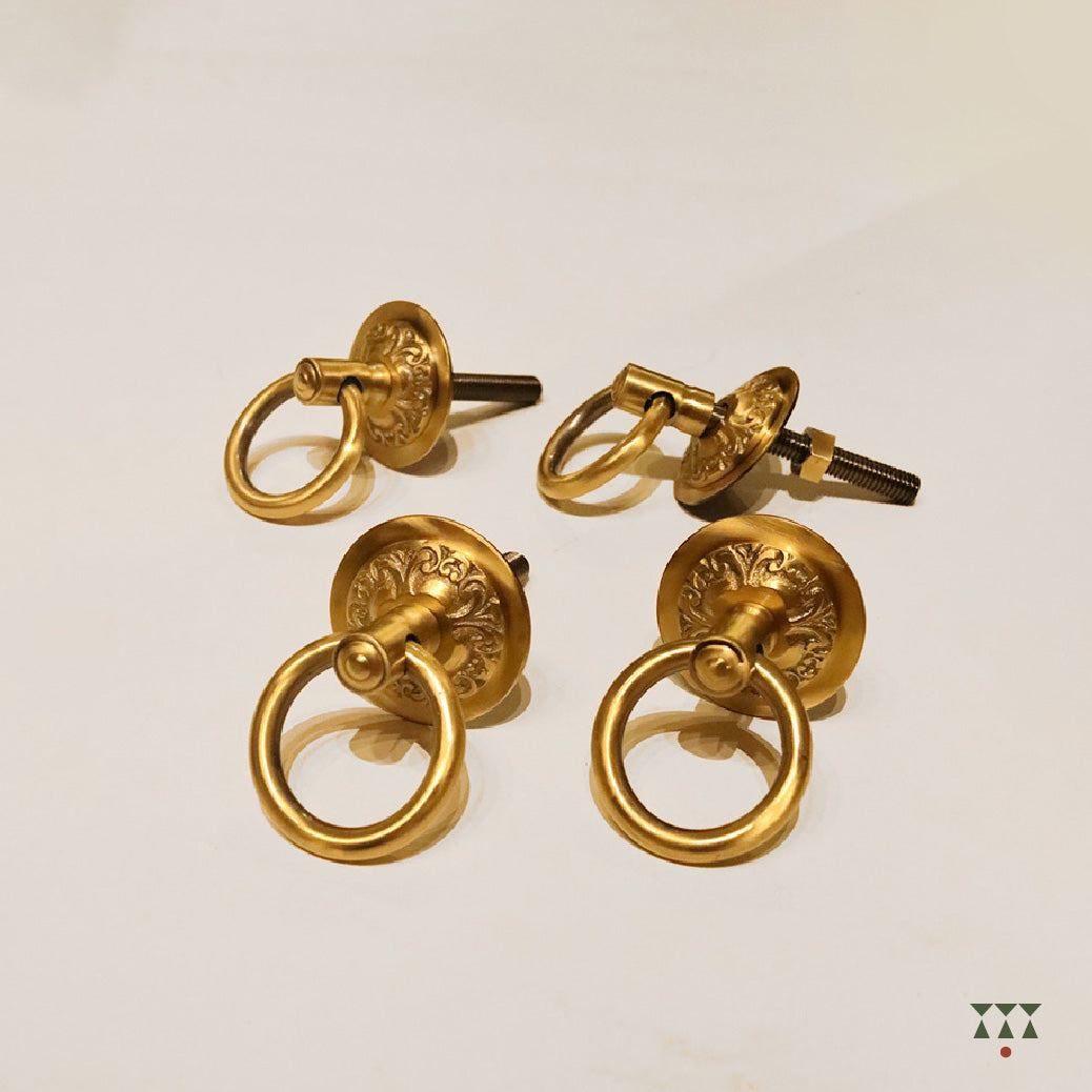 A close up of the pure brass individual hooks with intricate designs and motifs that suspend a swing