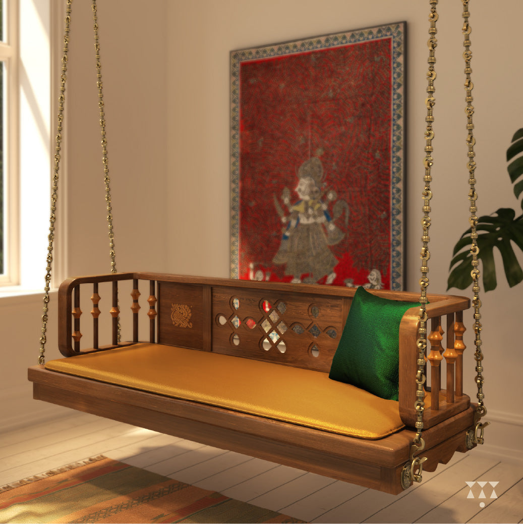 Close up of a wooden swing with Kolam, Annapakshi and floral designs and turning details on the backrest with a fabric seat
