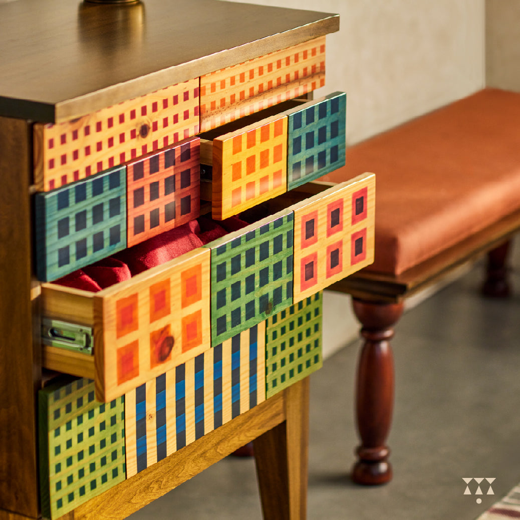 A petite chest of drawers with vibrant facade inspired by the color blocks of Madras check textiles, crafted in solid wood