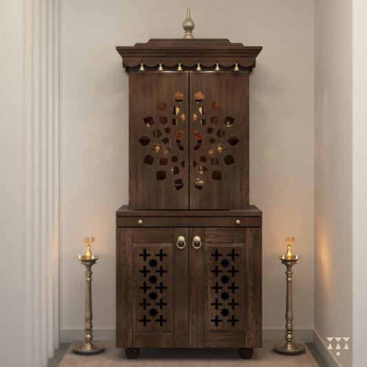 A tall wooden mandir with doors, pure brass elements, cutwork designs and storage, tinted in mocha brown