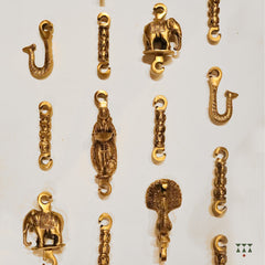 A close up of the pure brass individual chain links with intricate designs and motifs that suspends a swing