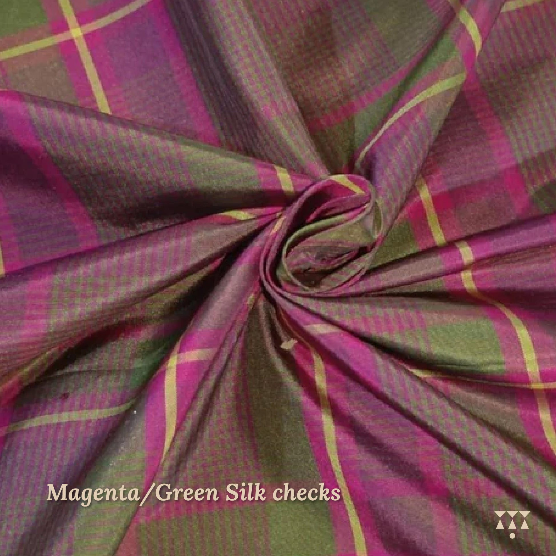 Close up of a magenta and green checked silk upholstery option for a solid wood wing chair