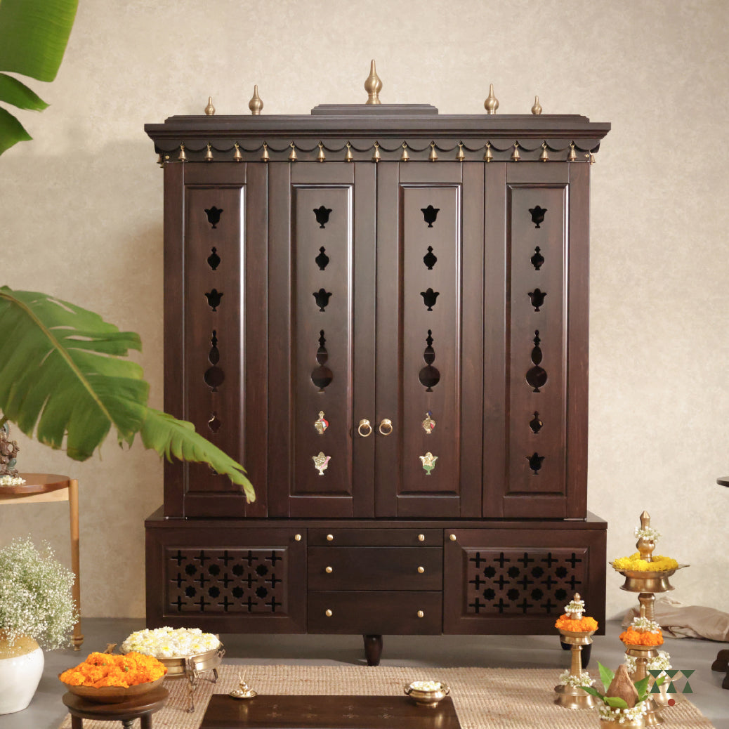 Decorative wooden temple cabinet with intricate carvings in a room setting.