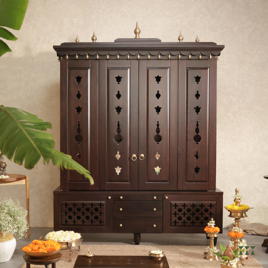 Decorative wooden temple cabinet with intricate carvings in a room setting.