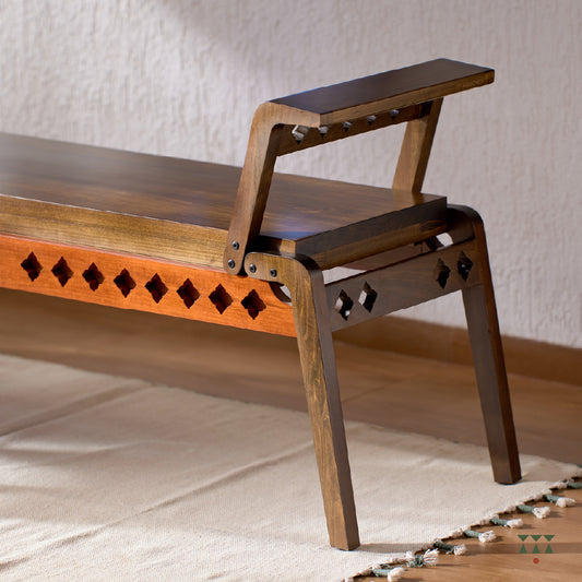 Close up of the sharp geometry and cutwork of a wooden bench, tinted in Mocha Brown with a Saffron Orange accent