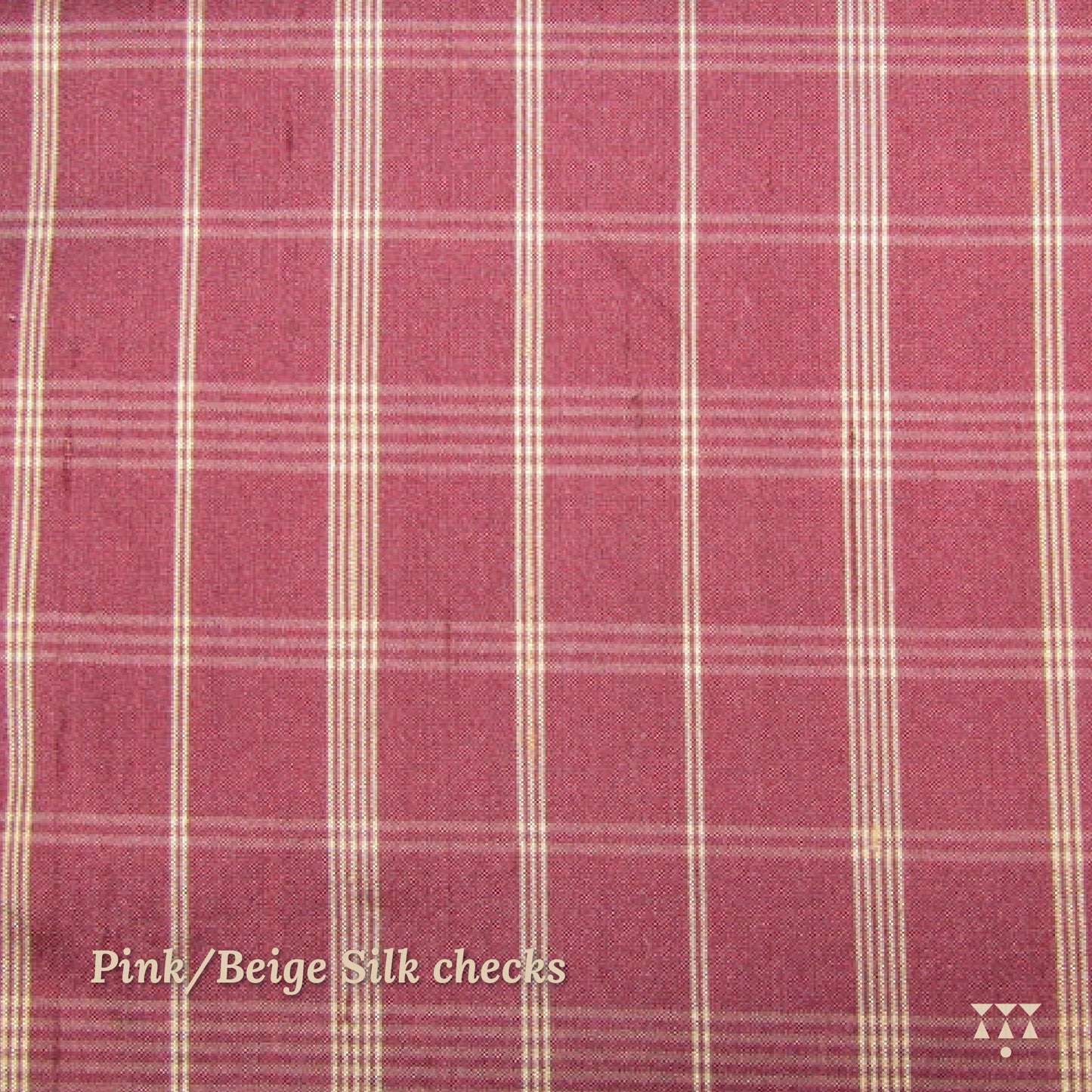 Close up of a pink and beige checked silk upholstery option for a solid wood wing chair