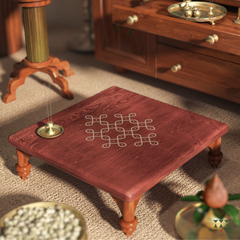 Wooden table with kolam design in a warm-toned room