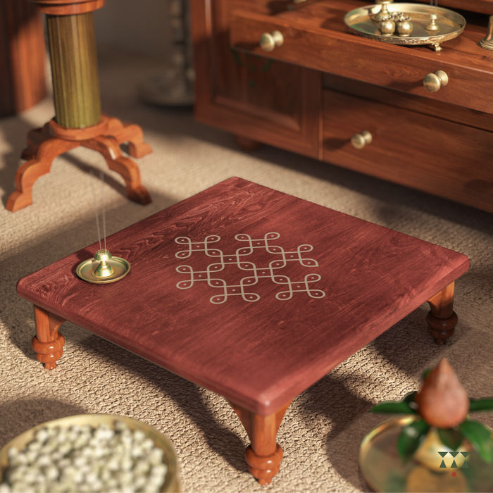 Wooden table with kolam design in a warm-toned room