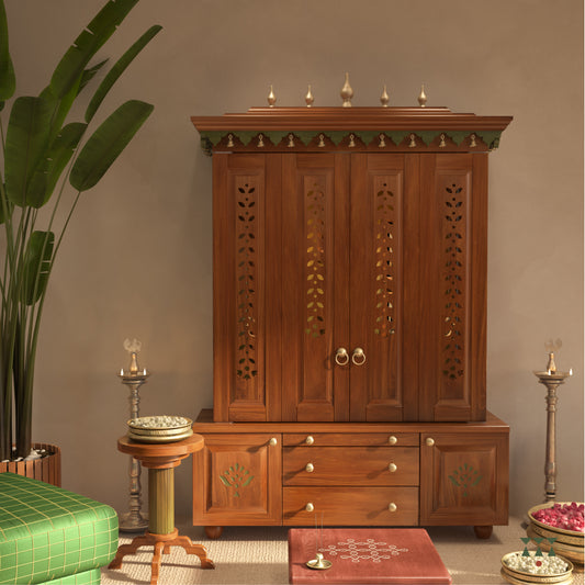 A solid wood mandir with doors, pure brass bells, accessories, cutwork designs and storage, tinted in an almond brown color