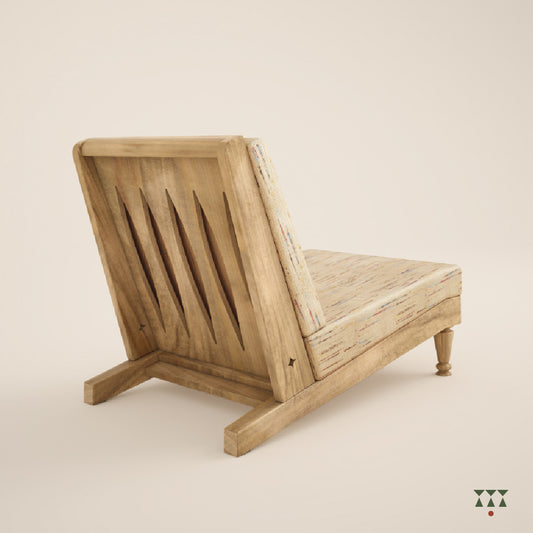 The cutwork back of a low solid wood lounge chair with a multicolored beige silk upholstery, tinted in sand brown