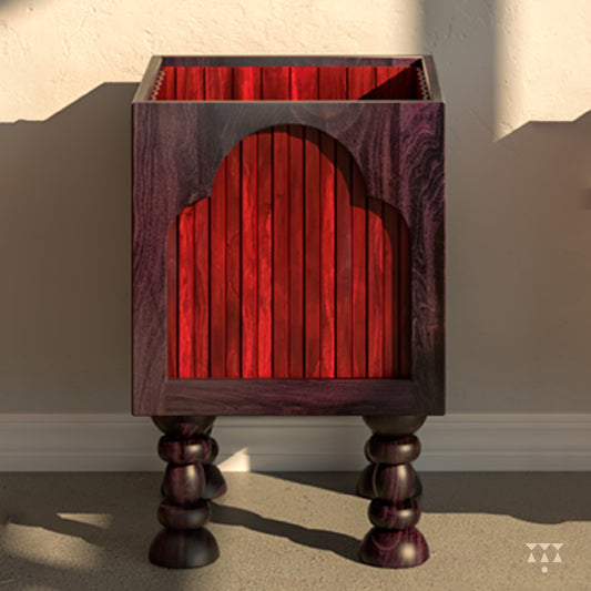 Close up of a box planter tinted with a purple and red accent, layered with arch shapes and turned legs 