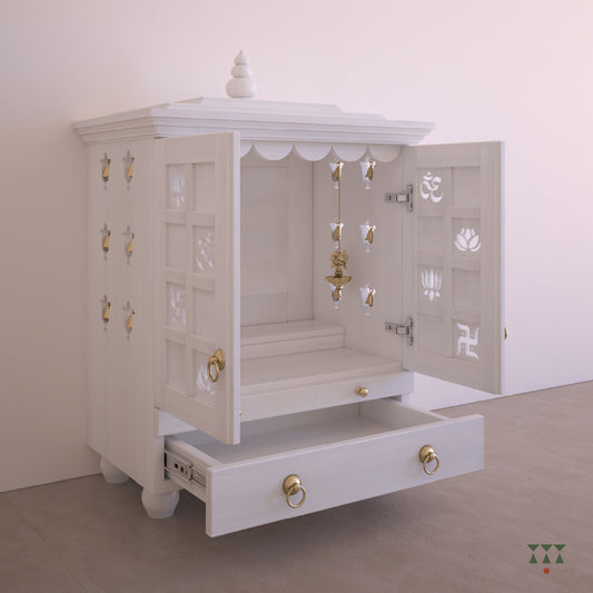 A solid wood mandir with doors, pure brass bells, cutwork designs and storage, tinted in snow white