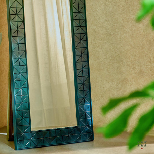 A solid wood full length mirror with a stand and a geometric, textured frame tinted in Moringa Green & Lagoon Blue