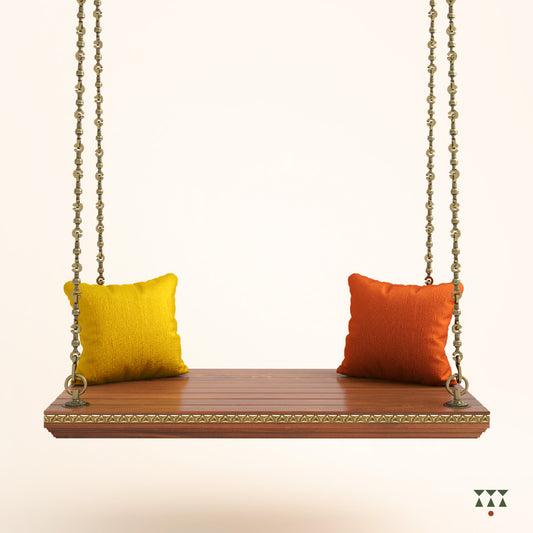 A handcrafted wooden swing base tinted in almond brown with decorative edging, brass chains and cushions