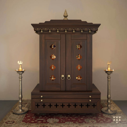 A wooden mandir with doors, pure brass elements, cutwork designs and storage, tinted in tamarind brown