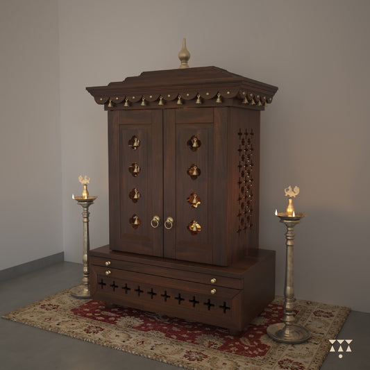 A wooden mandir with doors, pure brass elements, cutwork designs and storage, tinted in tamarind brown
